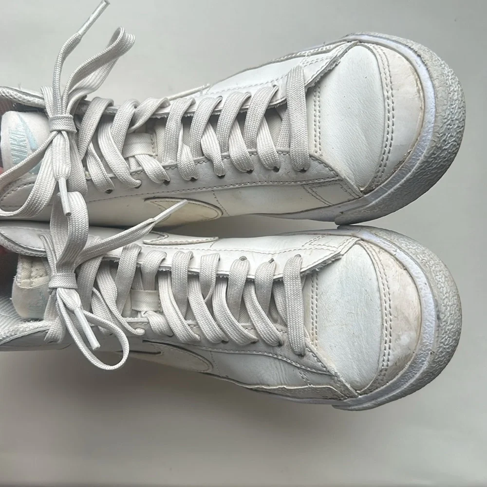 Cream colored Nike blazers size 4Y with Lavender sole and heal details